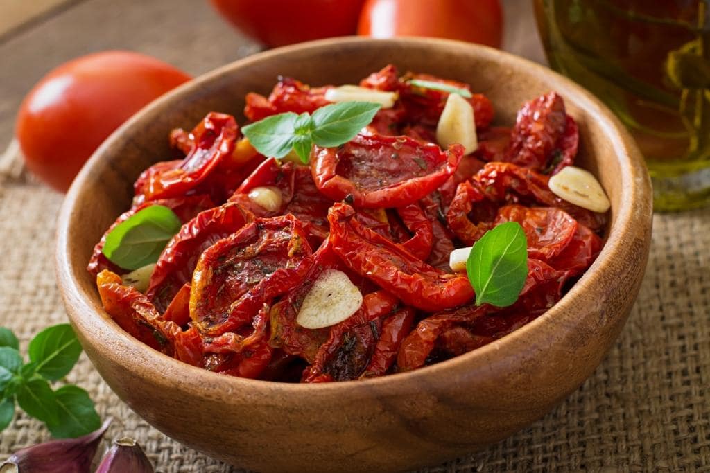 sun-dried-tomatoes-with-herbs-garlic-wooden-bowl