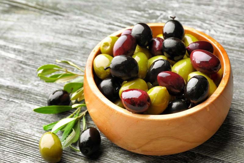 Olives in wooden large bowl 